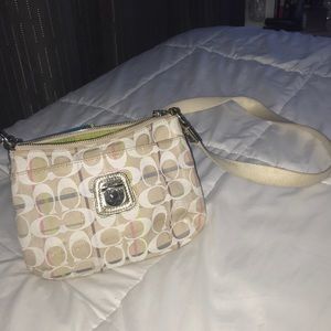 Woman’s vintage white coach purse